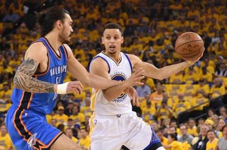 Oakland CA USA Golden State Warriors guard Stephen Curry controls the basketball against Oklahoma City Thunder center Steven Adams during the first quarter in game two of the Western conference finals of the NBA Playoffs at Orac