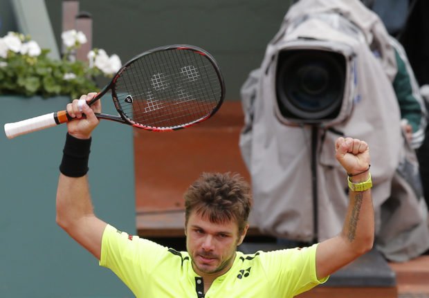 Defending champion Switzerland's Stan Wawrinka celebrates after defeating Czech Republic's Lukas Rosol during their first round match of the French Open tennis tournament at the Roland Garros stadium Monday