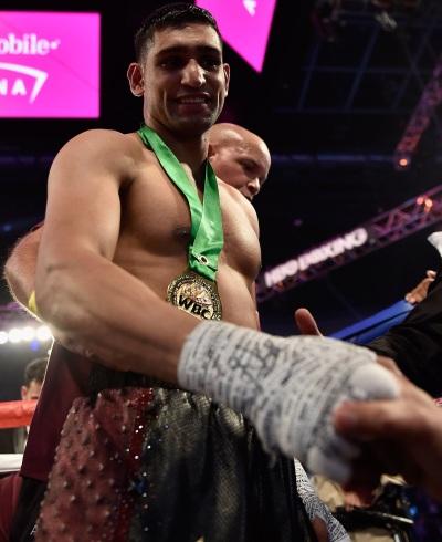 Khan leaves the ring apparently suffering no lasting damage from his KO. Pic Getty Images