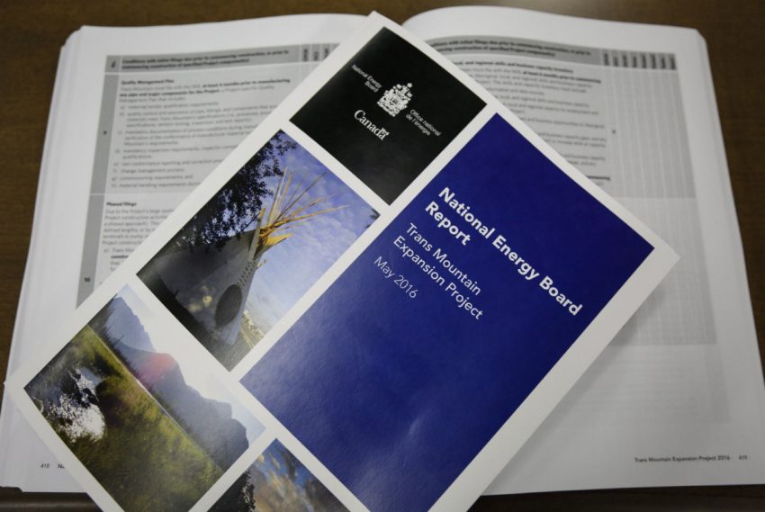 Copies of the National Energy Board report on the Trans Mountain pipeline expansion project are seen in Calgary on Thursday