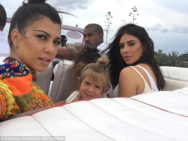 Missing Cuba The Keeping Up With The Kardashians star shared a selfie as she rode with daughter Penelope and sister Kim Kardashian Kanye West and their daughter North in a pink vintage convertible