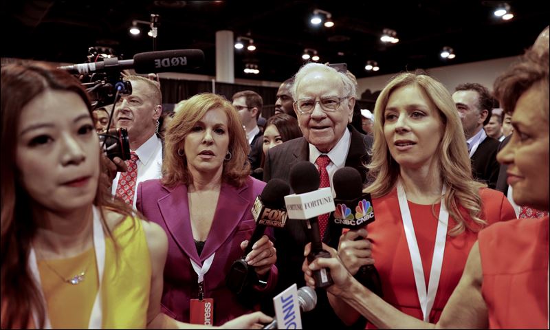 Berkshire Hathaway Chairman and CEO Warren Buffett tours the exhibit floor before presiding over the annual shareholders meeting Saturday in Omaha Neb