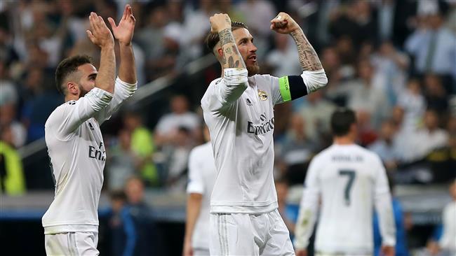 Real Madrid's defender Dani Carvajal and Real Madrid's defender Sergio Ramos celebrate their victory at the end the UEFA Champions League semi-final second leg football match Real Madrid CF vs Manchester City FC at the Santiago Bernabeu stadiu