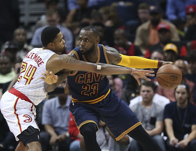 Cleveland Cavaliers forward Le Bron James works against Atlanta Hawks forward Kent Bazemore during the first half of an NBA basketball game in Atlanta. Game 1 of the Eastern Conference semifinal series