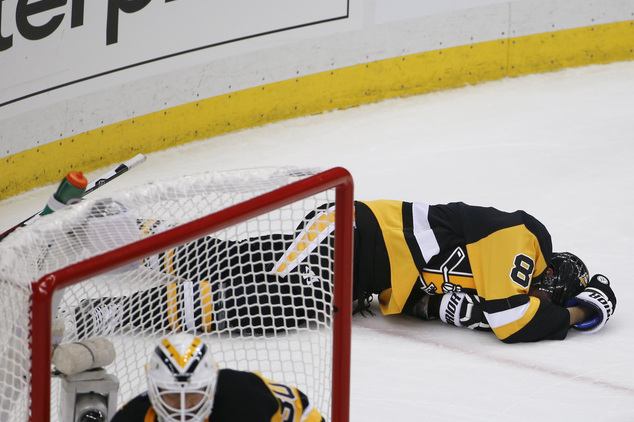 Pittsburgh Penguins Brian Dumoulin lies on the ice after being hit into the boards by Tampa Bay Lightning's Ondrej Palat during the third period of Game 1