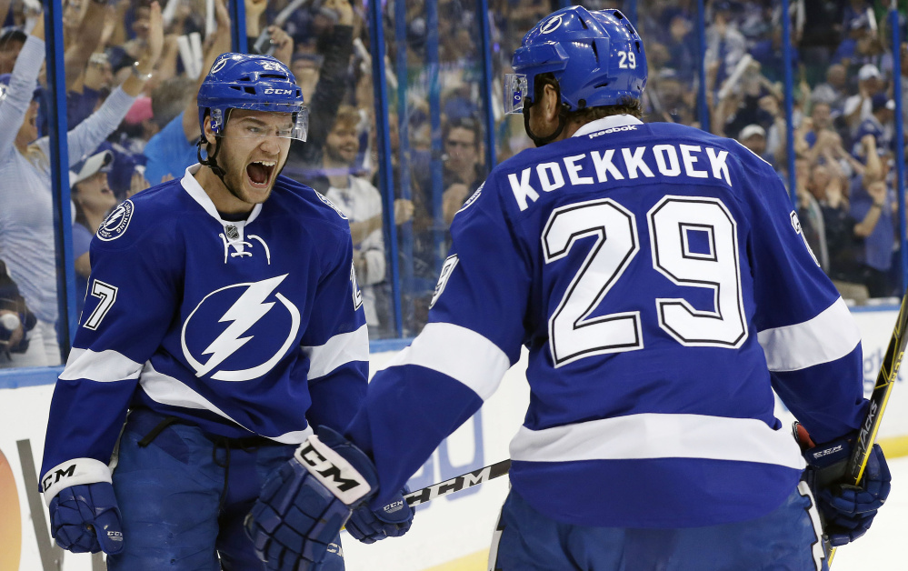 Tampa Bay left wing Jonathan Drouin left celebrates with defenseman Slater Koekkoek after Drouin's goal gave the Lightning a two-goal lead in the first period of their 4-1 win over the New York Islanders on Saturday in Tampa Florida