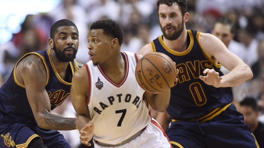 Toronto Raptors guard Kyle Lowry drives around Cleveland Cavaliers center Tristan Thompson as Cavaliers forward Le Bron James look on during first half Eastern Conference final playoff basketball action in Toronto on Monday