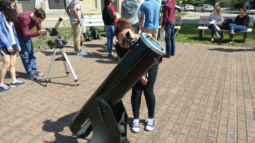 MHS student Ana Perez views the transit of Mercury through a telescope fitted with a solar filter