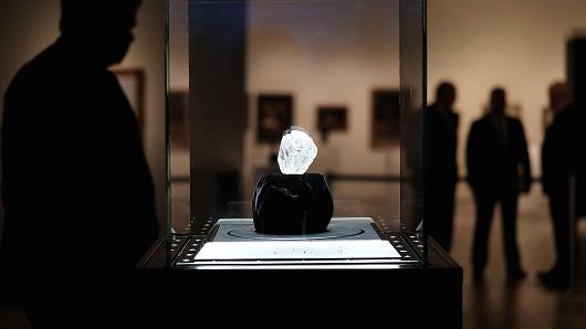 Guards stand next to the 1,109-carat rough Lesedi La Rona diamond the biggest rough diamond discovered in more than a century at Sotheby's