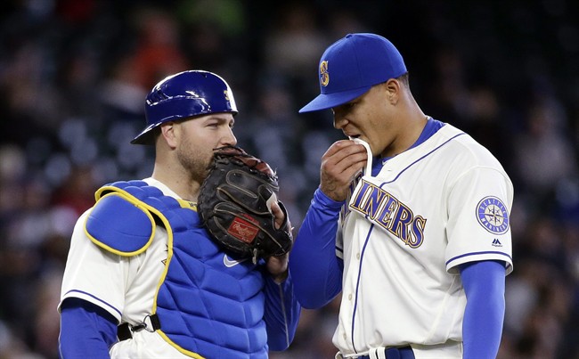 Seattle Mariners catcher Chris Iannetta left and starting pitcher Taijuan Walker talk after Walker gave up two home runs to the Minnesota Twins in the fourth inning of a baseball game Sunday