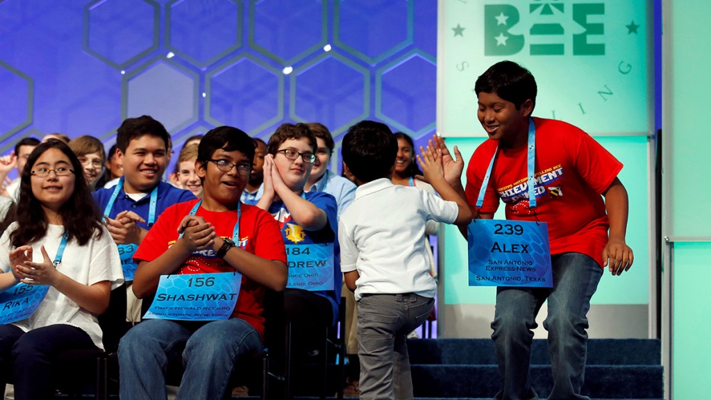 Akash Vukoti the youngest contestant at the 89th annual Scripps National Spelling Bee gets a high-five after successfully spelling a word during a preliminary round at National Harbor in Maryland