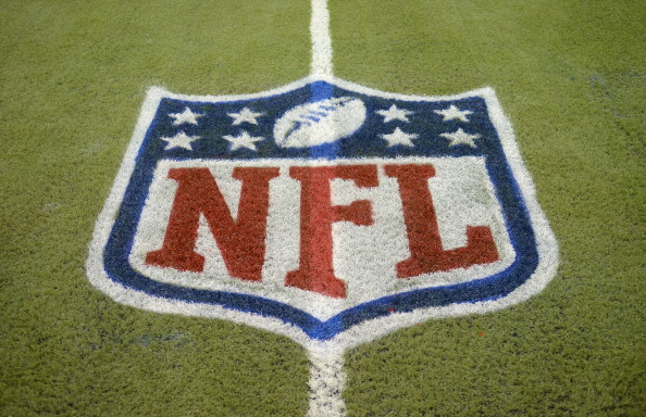 A detailed view of an NFL shield logo painted on the field before the game between the Indianapolis Colts and the Detroit Lions at Ford Field