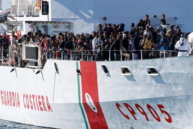 Migrants arrive by the Italian coastguard vessel Peluso in the Sicilian harbour of Augusta Italy in this