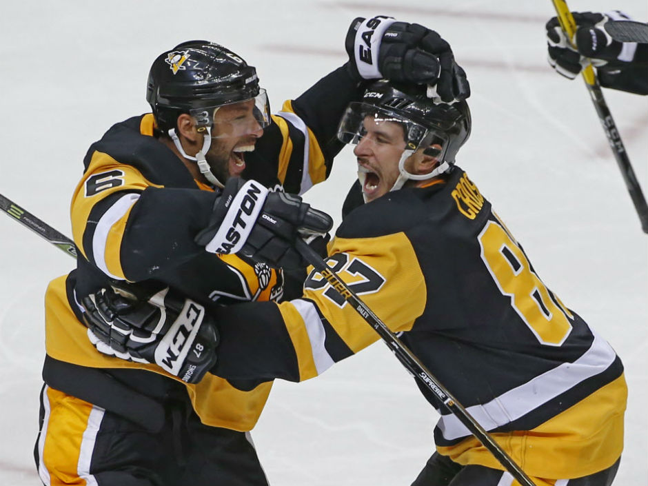 Trevor Daley left and Penguins teammate Sidney Crosby celebrate the winning goal against the Washington Capitals during the first overtime period of Game 4 of their Eastern Conference semifinals in Pittsburgh on Wednesday night