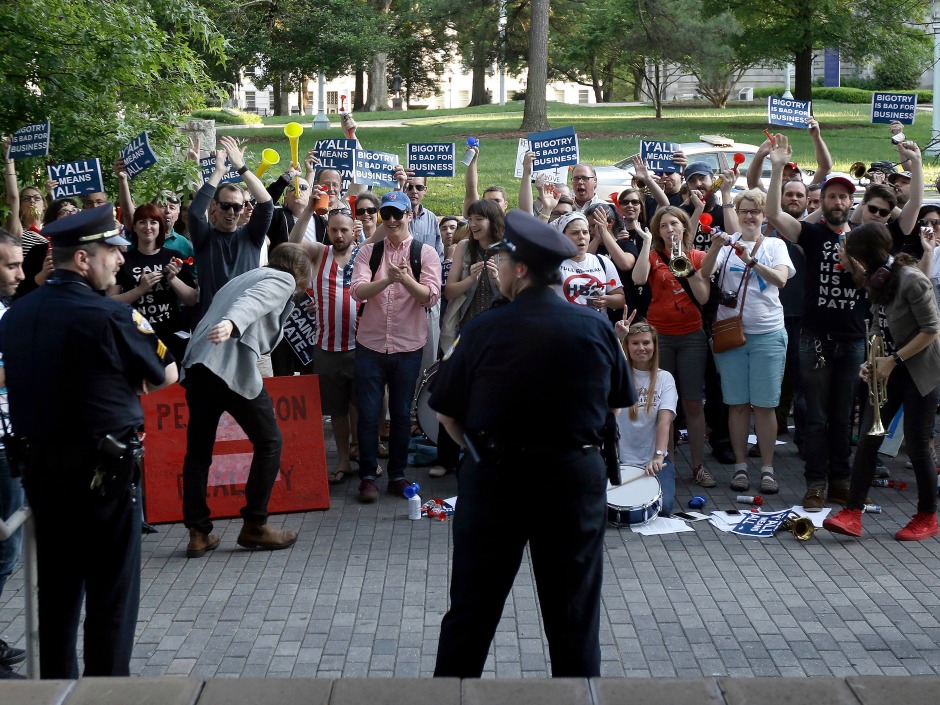 Protesters gather outside the the North Carolina Museum of History as Gov. Pat Mc Crory make remarks about House Bill 2 during a government affairs conference in Raleigh N.C. Wednesday