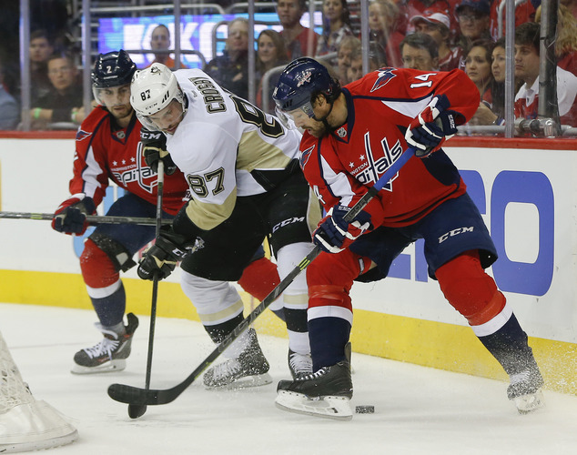 Pittsburgh Penguins center Sidney Crosby goes up against Washington Capitals defenseman Matt Niskanen right wing Justin Williams during the fir