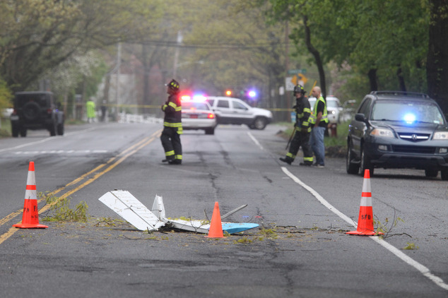 Aftermath Traffic cones mark the position of pieces from a Beech BE-35 light plane after the aircraft crashed in a residential neighborhood in Syosset on Tuesday