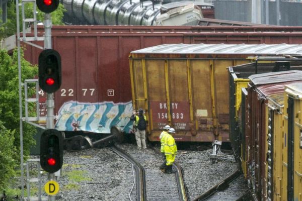 Several cars remain overturned after a CSX freight