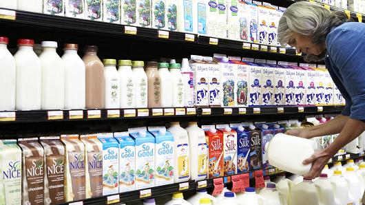 Woman looking at expiration date for milk