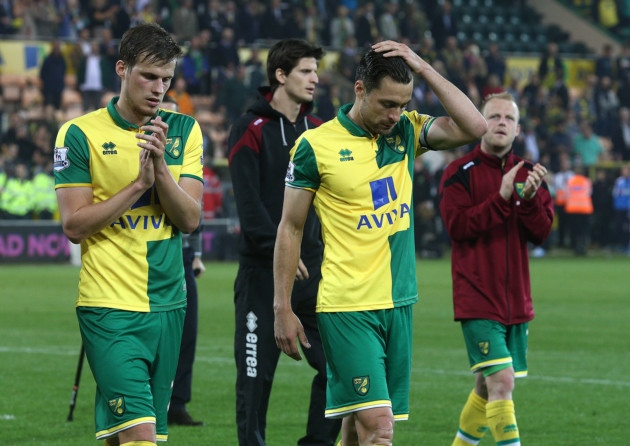 Russell Martin of Norwich and Ryan Bennett of Norwich look dejected during the lap of appreciation at the end of the Barclays Premier League match at Carrow Road Norwich