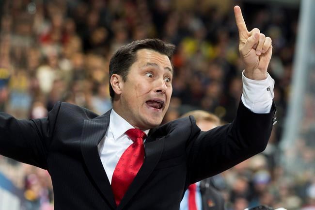 Team Canada's head coach Guy Boucher reacts during the match between Switzerland's HC Davos and Team Canada at the 89th Spengler Cup hockey tournament in Davos Switzerland Wednesday Dec. 30 2015. Boucher has been hired as the new head coach