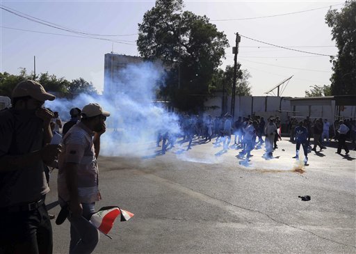 Iraqi security forces have fired tear gas and gunshots in the air as thousands of Shiite protesters stormed Baghdad’s heavily secured Green Z