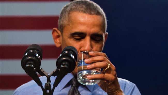 US President Barack Obama drinks a glass of water as he speaks at Flint Northwestern High School in Flint Michigan