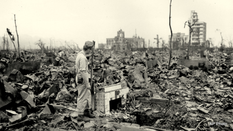 An unidentified man stands next to a tiled fireplace where a house once stood in Hiroshima Japan on Sept. 7 1945. The vast ruin is a result of'Little Boy' the uranium atomic bomb detonated on Aug. 6 by the U.S