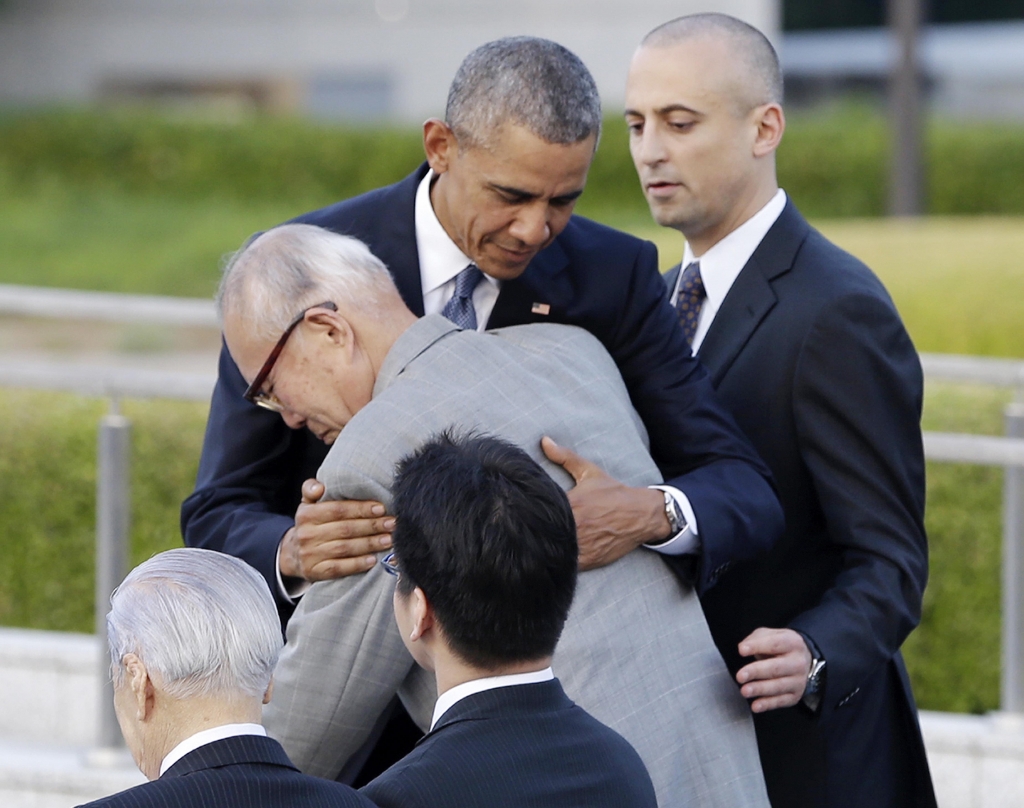 U.S. President Barack Obama hugs Shigeaki Mori an atomic bomb survivor creator of the memorial for American WWII POWs killed at Hiroshima during a ceremony at Hiroshima Peace Memorial Park in Hiroshima western Japan Friday