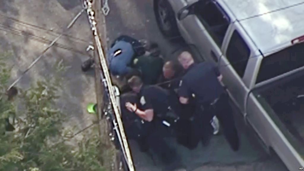 This aerial image made from a helicopter video provided by WHDH shows several officers allegedly pummeling Richard Simone who had exited his vehicle after a high-speed police pursuit in Nashua New Hampshire