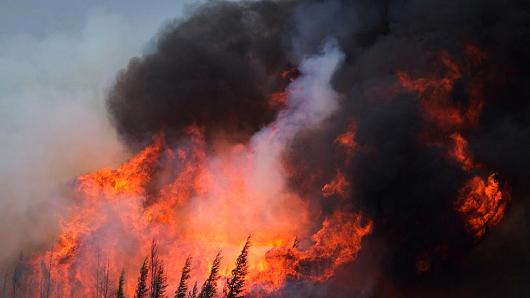 A wildfire burns on Highway 63 south of Fort McMurray Alberta Canada on Saturday