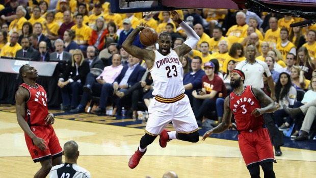 On top Cleveland's Le Bron James dunks the ball against the Toronto Raptors in game two of the NBA Eastern Conference finals