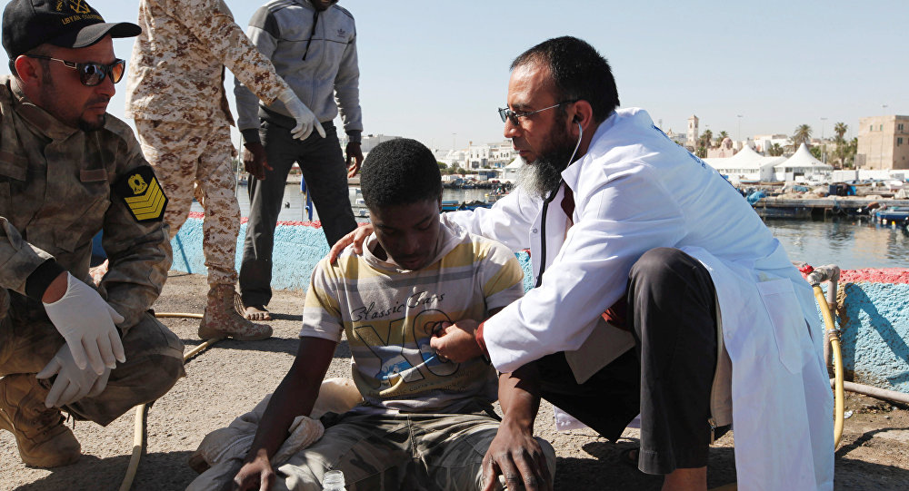 Migrants receive medical treatment in a port after being rescued at sea by Libyan coast guard in Tripoli Libya