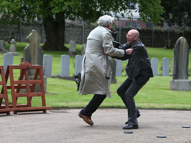 The Canadian Ambassador wrestles with the protester