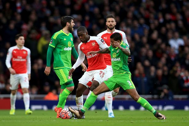 Arsenal's Joel Campbell and Sunderland's Patrick Van Aanholt battle for the ball