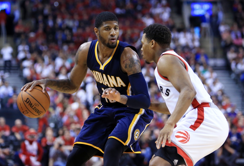 Paul George #13 of the Indiana Pacers dribbles the ball as Kyle Lowry #7 of the Toronto Raptors defends in the first half of Game Five of the Eastern Conference Quarterfinals during the 2016 NBA Playoffs at the Air Canada Centre