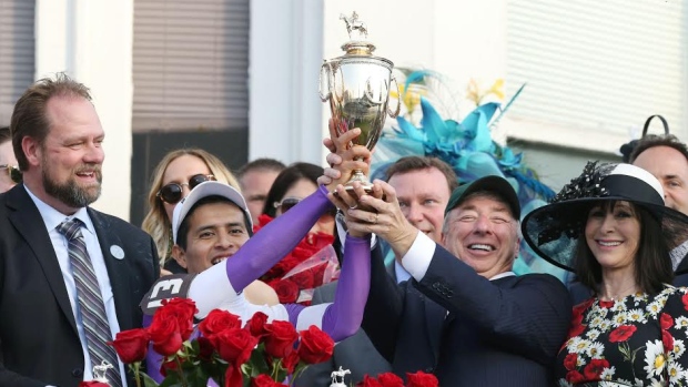 Paul Reddam right of Windsor Ont. celebrates Nyquist's win at the Kentucky Derby