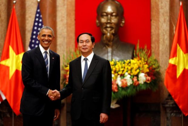 U.S. President Barack Obama shakes hands with Vietnam's President Tran Dai Quang after an arrival ceremony at the presidential palace in Hanoi Vietnam