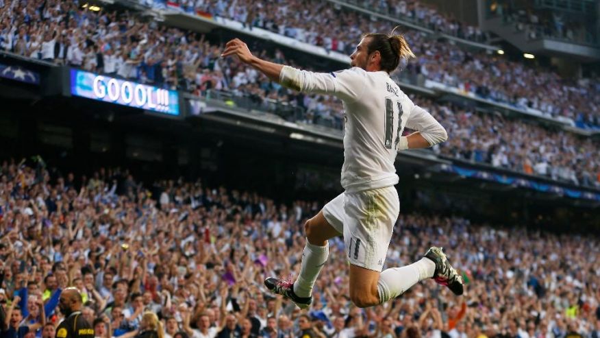 Real Madrid's Gareth Bale celebrates after scoring the opening goal during the Champions League semifinal second leg soccer match between Real Madrid and Manchester City at the Santiago Bernabeu stadium in Madrid Wednesday