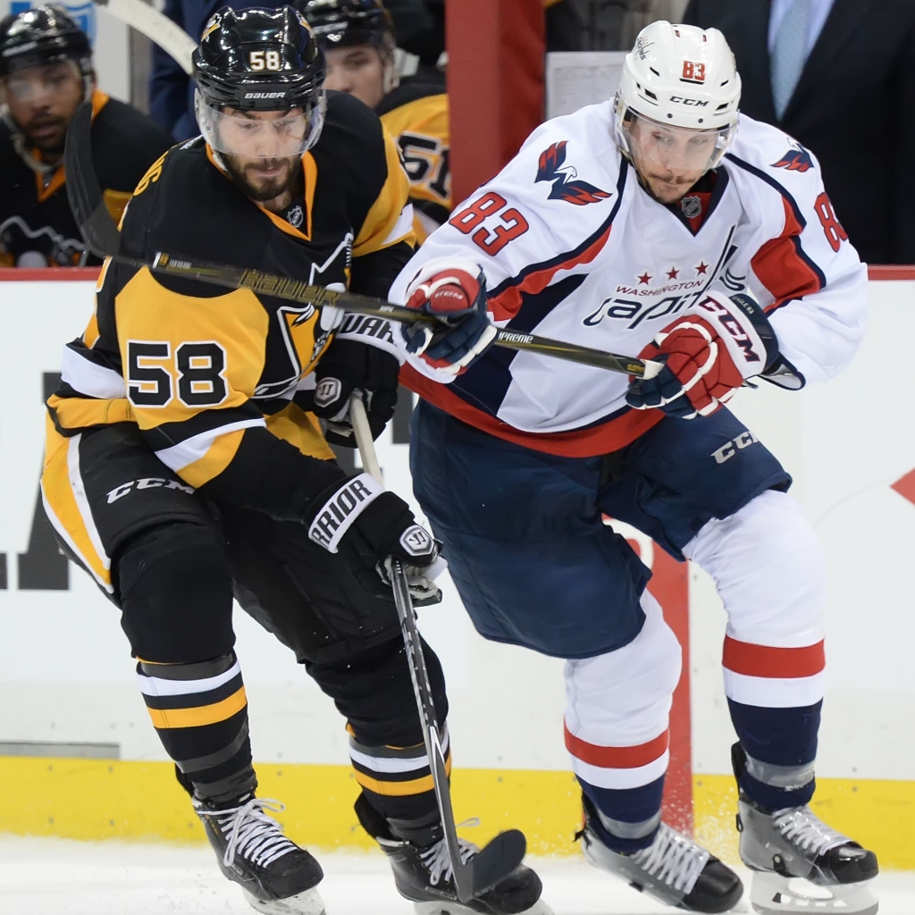 20160502pdPenguinsSports16 Pittsburgh Penguins Kris Letang battles for loose puck with the Capitals Jay Beagle in the third period at the Consol Energy Center Pittsburgh Pa