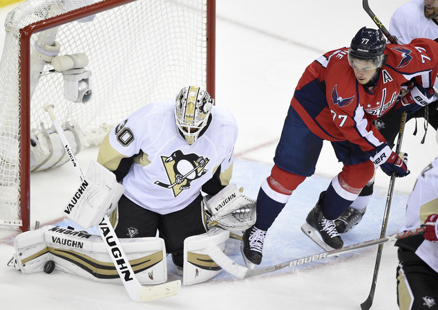 Pittsburgh Penguins goalie Matt Murray stops the puck as Washington Capitals right wing T.J. Oshie looks on during the third period of Game 5 in