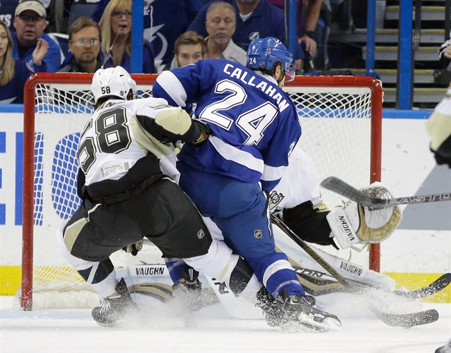 Tampa Bay Lightning's Ryan Callahan scores a goal past Pittsburgh Penguins goalie Matt Murray right as Kris Letang defends during the first period of Game 4 of the NHL hockey Stanley Cup Eastern Conference finals Friday