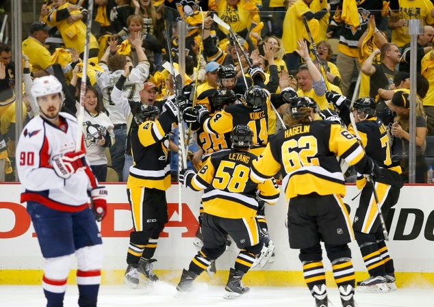 The Pittsburgh Penguins players celebrate the game winning OT goal by Nick Bonino against the Washington Capitals in Game Six of their Eastern Conference NH