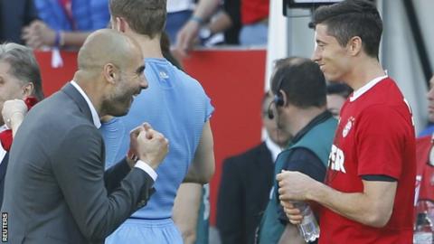 Bayern Munich boss Pep Guardiola celebrates with Robert Lewandowski after the final whistle