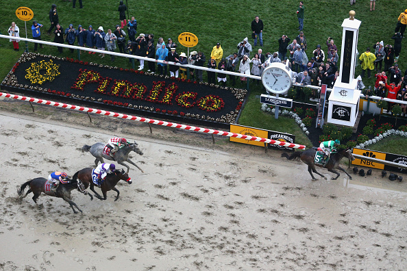 Exaggerator ridden by Kent Desormeaux leads the field to win the 141st running of the Preakness Stakes