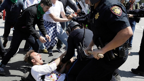 Police take a bellowing anti Trump protester into custody outside the Republican Party Convention in Burlingame