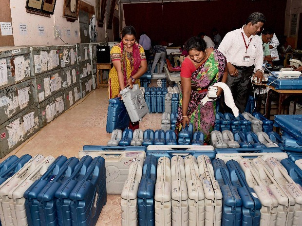 Polling officials check the Electronic Voting Machines at a distribution centre ahead of voting for Tamil Nadu assembly polls in Chennai