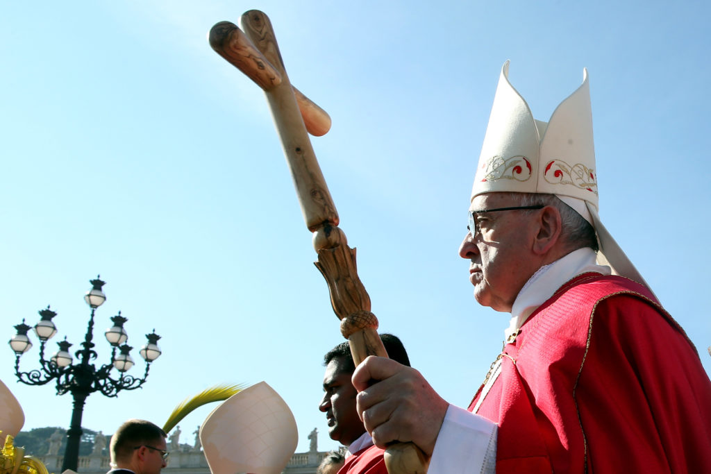 Pope Francis arrives in a procession for Sunday Palm Mass