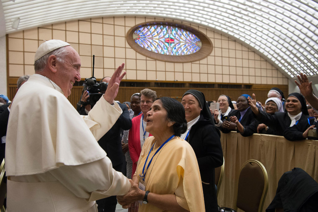 Pope Francis greets a nun during an audience with the heads of women's religious orders in Paul VI hall at the Vatican May 12. During a question-and-answer session with members of the UISG the pope said he was willing to establish a commission to study