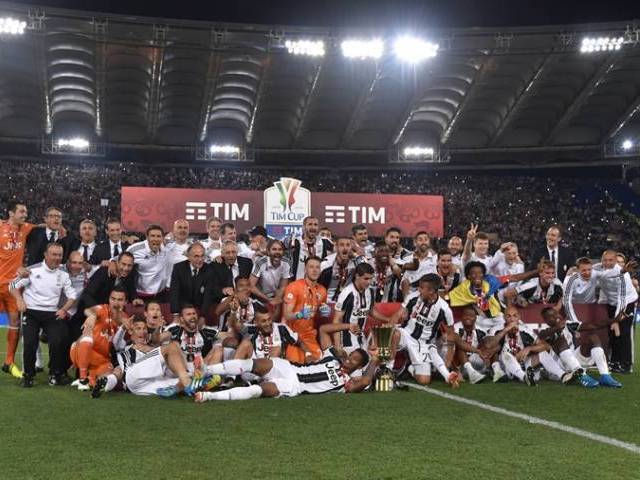 Juventus&#039 players pose with the trophy after winning the Italian Tim Cup final football match AC Milan vs Juventus